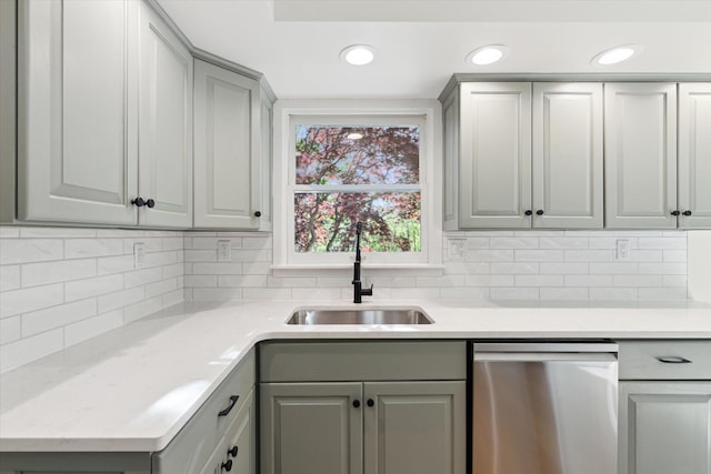 5082 Patland Dr, Kalamazoo, MI 49009 - kitchen with stainless steel dishwasher, gray cabinets, a sink, tasteful backsplash, and recessed lighting