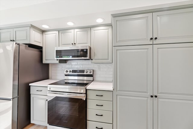 5082 Patland Dr, Kalamazoo, MI 49009 - kitchen with appliances with stainless steel finishes, light countertops, backsplash, and recessed lighting