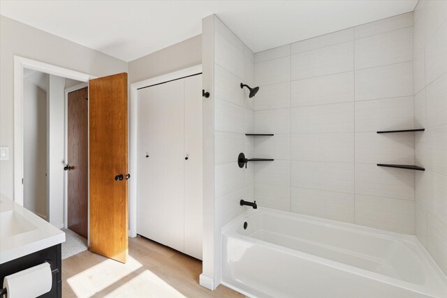 5082 Patland Dr, Kalamazoo, MI 49009 - full bathroom featuring wood finished floors, washtub / shower combination, and vanity