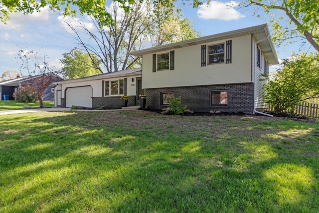 5082 Patland Dr, Kalamazoo, MI 49009 - split level home featuring brick siding, a garage, concrete driveway, and stucco siding