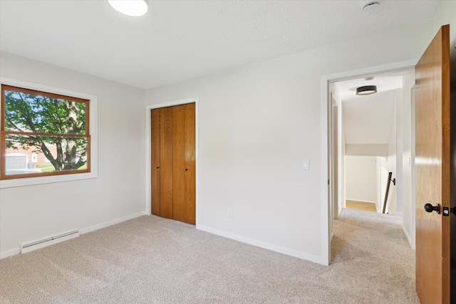 5082 Patland Dr, Kalamazoo, MI 49009 - spare room with a baseboard heating unit, carpet flooring, and baseboards