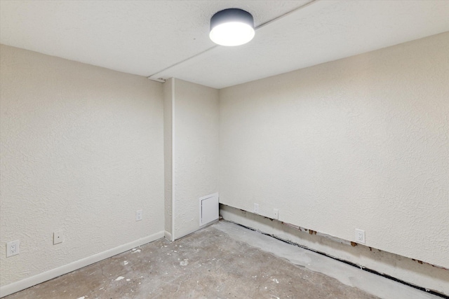 5082 Patland Dr, Kalamazoo, MI 49009 - empty room featuring unfinished concrete floors, baseboards, and a textured wall