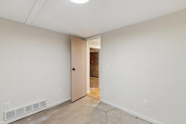 5082 Patland Dr, Kalamazoo, MI 49009 - empty room featuring baseboards, concrete flooring, and a textured wall