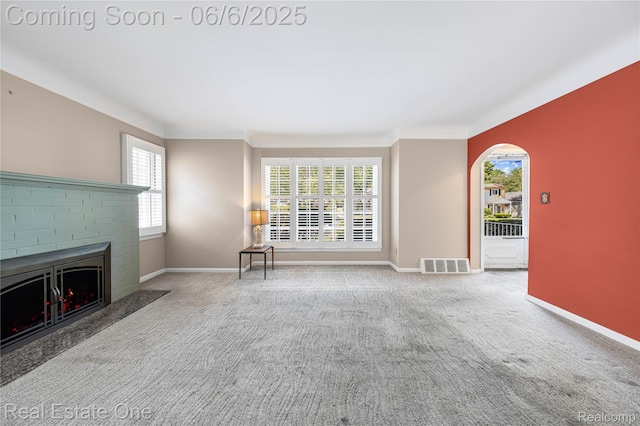 2209 Ridgemont Rd, Grosse Pointe Woods, MI 48236 - unfurnished living room with carpet floors, a fireplace, baseboards, and arched walkways