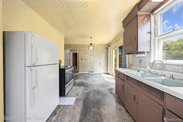 2209 Ridgemont Rd, Grosse Pointe Woods, MI 48236 - kitchen featuring freestanding refrigerator, stainless steel electric range, a sink, arched walkways, and plenty of natural light