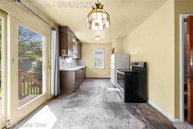 2209 Ridgemont Rd, Grosse Pointe Woods, MI 48236 - kitchen featuring stainless steel electric range oven, light countertops, a sink, freestanding refrigerator, and baseboards