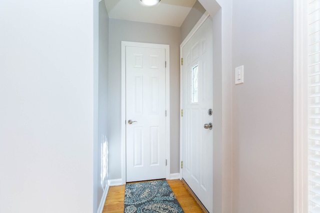 entryway featuring light wood finished floors and baseboards