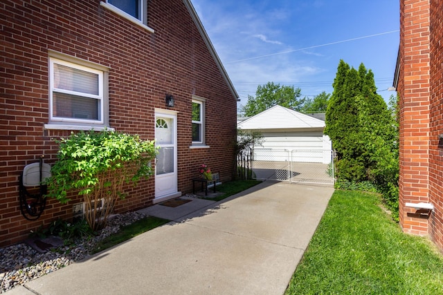 view of home's exterior with an outbuilding, brick siding, and a garage