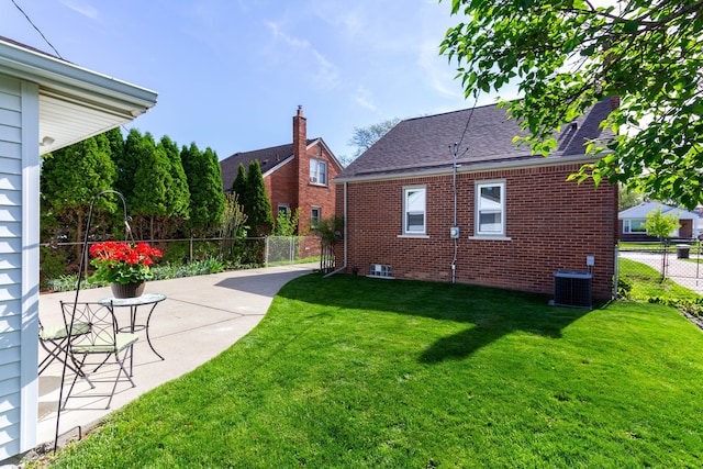 view of property exterior featuring brick siding, a patio area, cooling unit, and roof with shingles