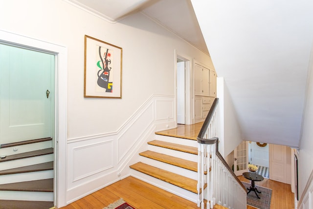 736 Chicago Blvd, Detroit, MI 48202 - staircase featuring a decorative wall, wood finished floors, a wainscoted wall, and ornamental molding