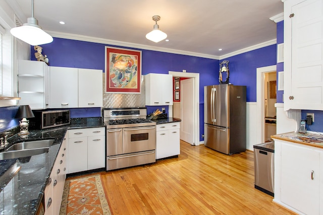 736 Chicago Blvd, Detroit, MI 48202 - kitchen featuring appliances with stainless steel finishes, a sink, white cabinetry, crown molding, and light wood-style flooring