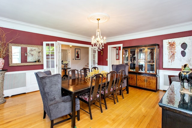 736 Chicago Blvd, Detroit, MI 48202 - dining room with radiator, a chandelier, ornamental molding, a wainscoted wall, and light wood-style floors