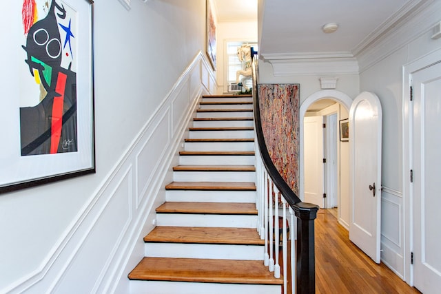 736 Chicago Blvd, Detroit, MI 48202 - stairs with crown molding, arched walkways, wood finished floors, and a decorative wall