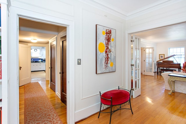 736 Chicago Blvd, Detroit, MI 48202 - hallway with ornamental molding, french doors, and light wood finished floors