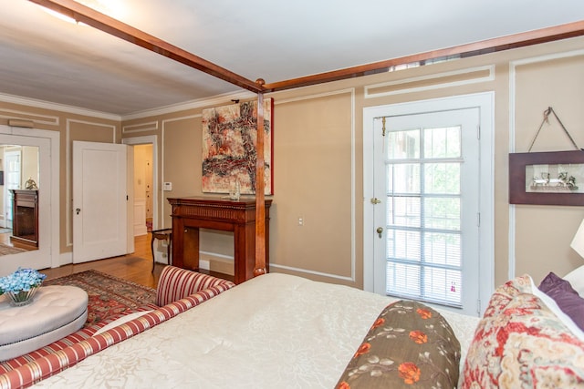 736 Chicago Blvd, Detroit, MI 48202 - bedroom featuring multiple windows, ornamental molding, and wood finished floors