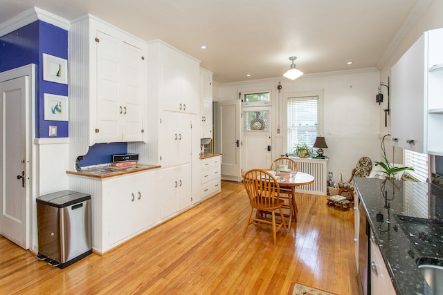 736 Chicago Blvd, Detroit, MI 48202 - kitchen featuring light wood-type flooring, white cabinets, radiator heating unit, crown molding, and recessed lighting