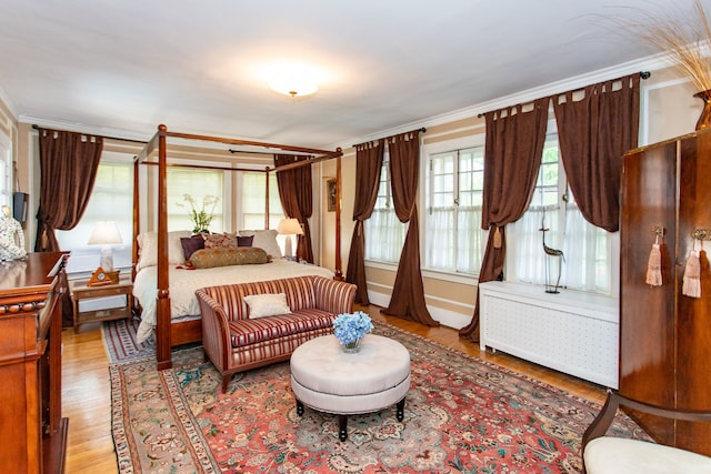 736 Chicago Blvd, Detroit, MI 48202 - bedroom featuring radiator heating unit, wood finished floors, and crown molding
