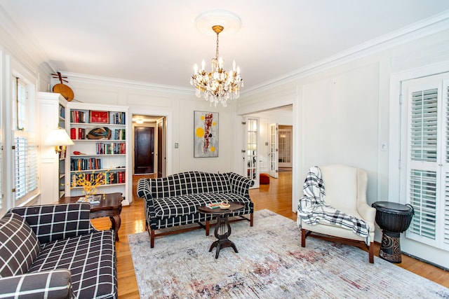 736 Chicago Blvd, Detroit, MI 48202 - living area featuring crown molding, a chandelier, light wood-style floors, and a decorative wall
