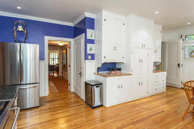 736 Chicago Blvd, Detroit, MI 48202 - kitchen with freestanding refrigerator, crown molding, light wood-style floors, white cabinetry, and plenty of natural light