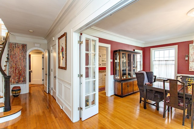 736 Chicago Blvd, Detroit, MI 48202 - dining space featuring stairway, crown molding, light wood-type flooring, and arched walkways