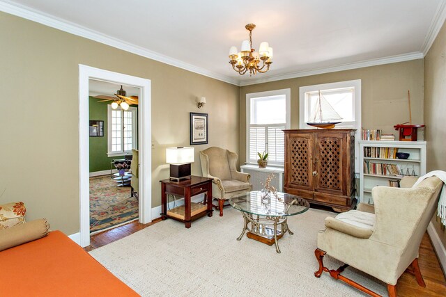 736 Chicago Blvd, Detroit, MI 48202 - living area with healthy amount of natural light, a chandelier, ornamental molding, wood finished floors, and baseboards