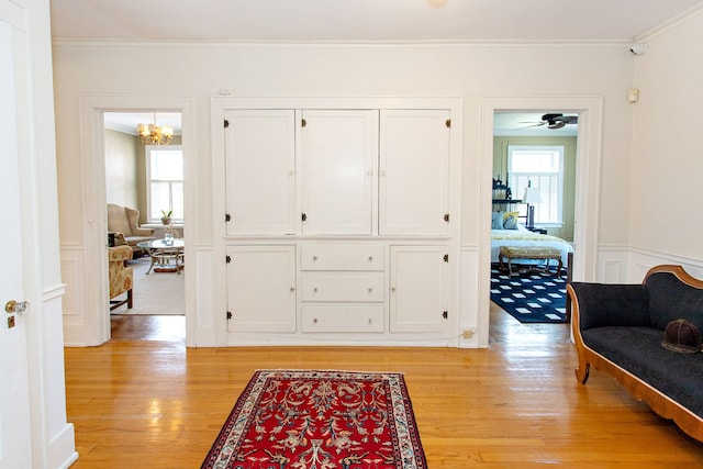 736 Chicago Blvd, Detroit, MI 48202 - entryway with crown molding, light wood finished floors, healthy amount of natural light, a chandelier, and wainscoting
