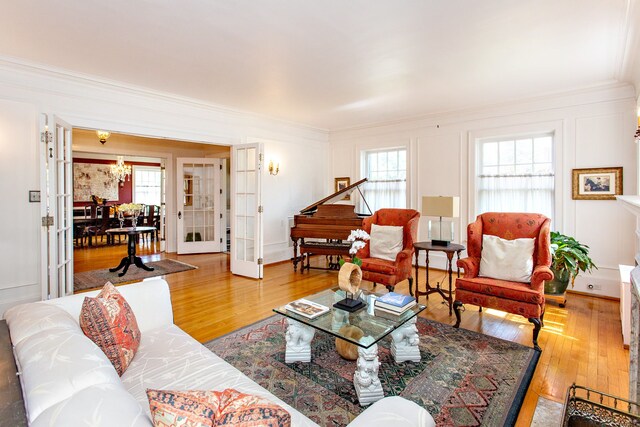 736 Chicago Blvd, Detroit, MI 48202 - living room with hardwood / wood-style floors, crown molding, french doors, and a chandelier