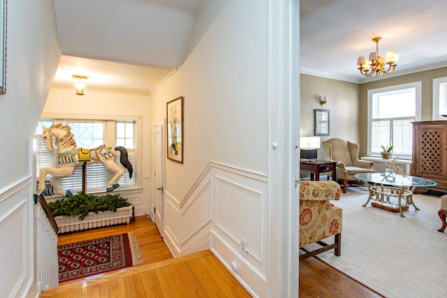 736 Chicago Blvd, Detroit, MI 48202 - corridor featuring a decorative wall, crown molding, wood finished floors, a chandelier, and a wainscoted wall