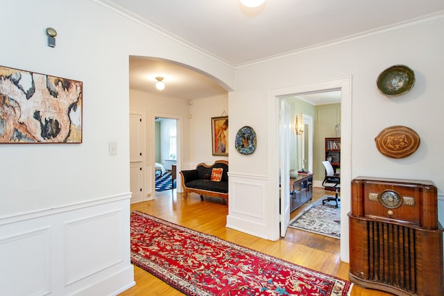 736 Chicago Blvd, Detroit, MI 48202 - hall featuring light wood finished floors, crown molding, arched walkways, wainscoting, and an office area