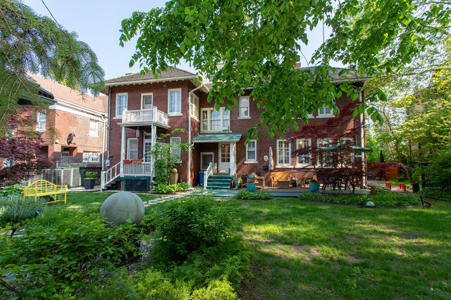 736 Chicago Blvd, Detroit, MI 48202 - rear view of property featuring brick siding, a lawn, and a balcony