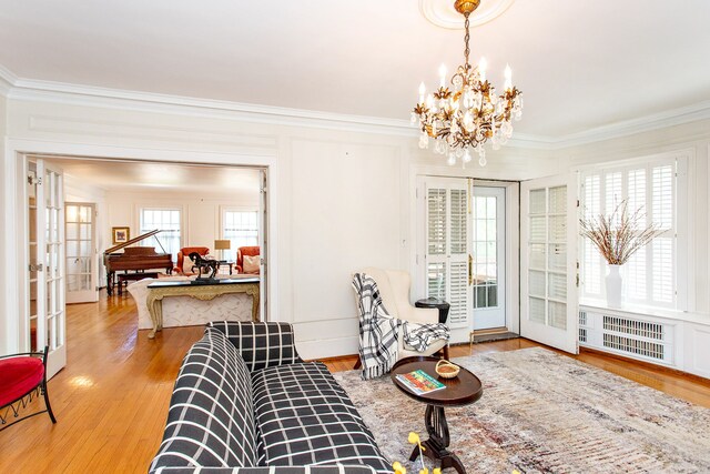 736 Chicago Blvd, Detroit, MI 48202 - living area with crown molding, a chandelier, french doors, radiator heating unit, and wood finished floors
