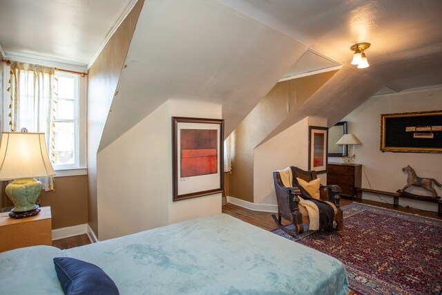 736 Chicago Blvd, Detroit, MI 48202 - bedroom with wood finished floors, vaulted ceiling, and baseboards