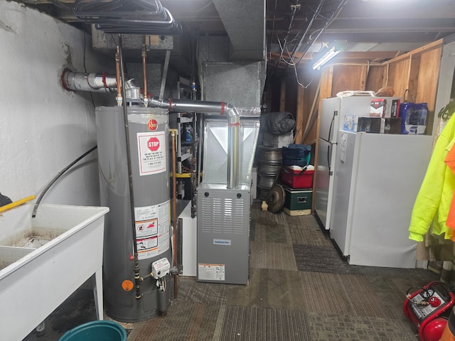 26541 Warner Ave, Warren, MI 48091 - utility room featuring gas water heater and a sink