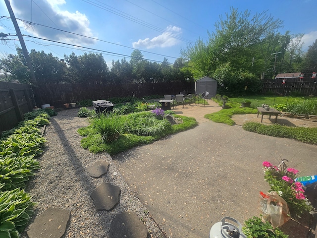 26541 Warner Ave, Warren, MI 48091 - fenced backyard with a patio area, a storage shed, and an outbuilding