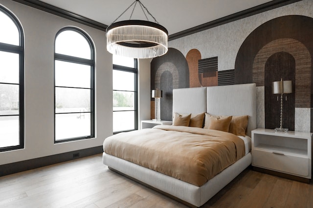 bedroom with wood finished floors and arched walkways