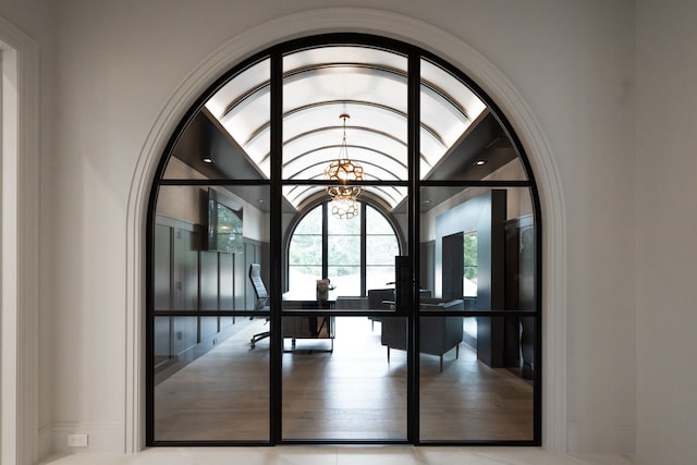 detailed view of an office area, arched walkways, and a chandelier