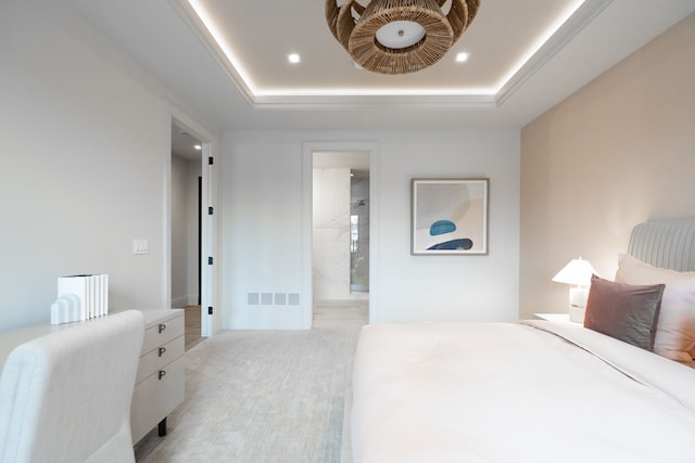 bedroom featuring recessed lighting, light carpet, a raised ceiling, and ensuite bathroom