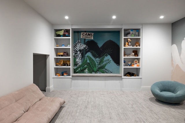 living area featuring recessed lighting and baseboards