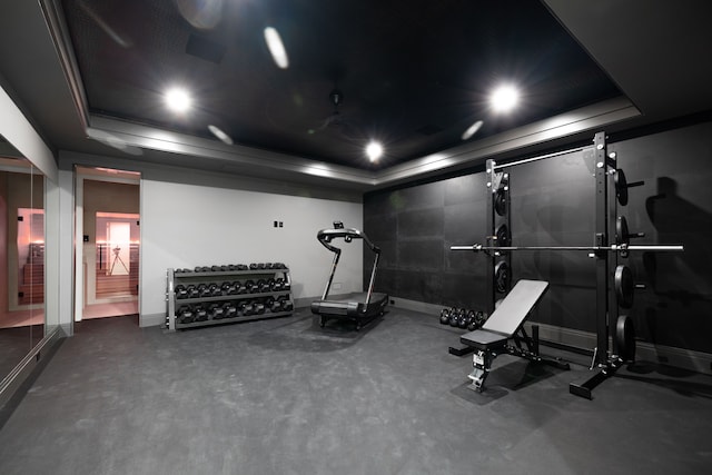 workout room with a tray ceiling, baseboards, and recessed lighting