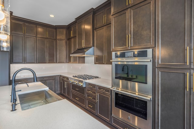5636 Suffolk Ct, West Bloomfield, MI 48322 - kitchen with stainless steel appliances, a sink, light countertops, decorative backsplash, and recessed lighting