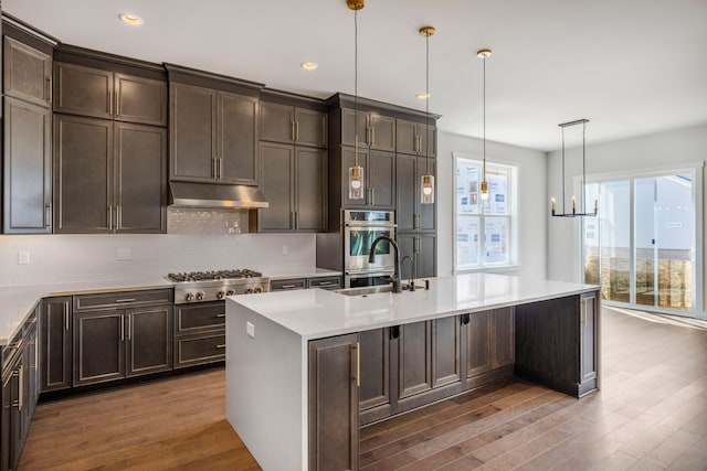 5636 Suffolk Ct, West Bloomfield, MI 48322 - kitchen with stainless steel gas cooktop, wood finished floors, under cabinet range hood, backsplash, and recessed lighting