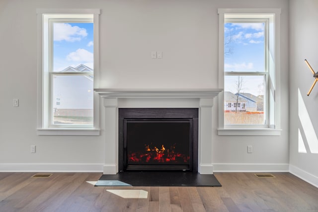 5636 Suffolk Ct, West Bloomfield, MI 48322 - detailed view of a fireplace with flush hearth, wood finished floors, and baseboards