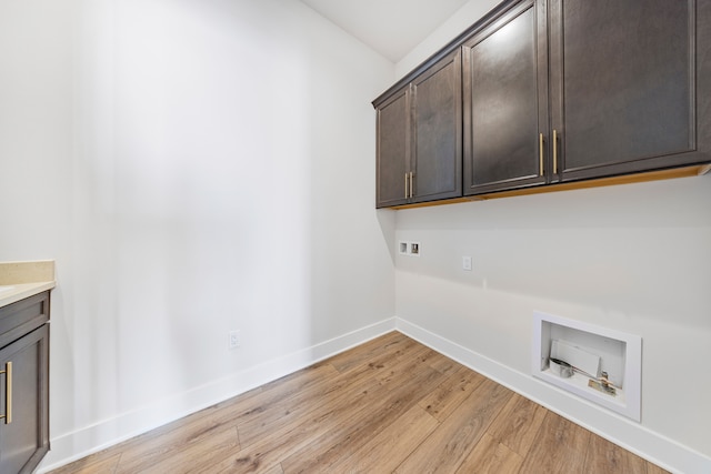 5636 Suffolk Ct, West Bloomfield, MI 48322 - clothes washing area featuring hookup for a washing machine, cabinet space, light wood-style floors, and baseboards