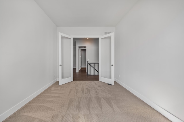 5636 Suffolk Ct, West Bloomfield, MI 48322 - unfurnished room featuring light carpet, baseboards, and french doors