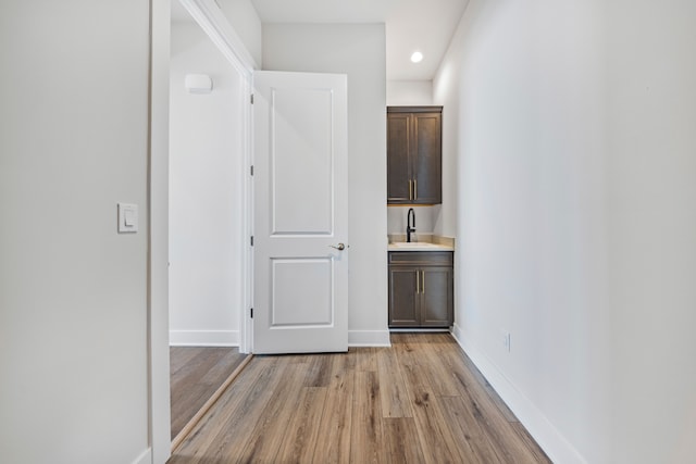 5636 Suffolk Ct, West Bloomfield, MI 48322 - corridor with a sink, light wood-style flooring, recessed lighting, and baseboards