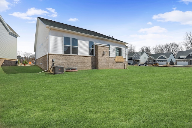 5636 Suffolk Ct, West Bloomfield, MI 48322 - back of property featuring brick siding, a lawn, and cooling unit