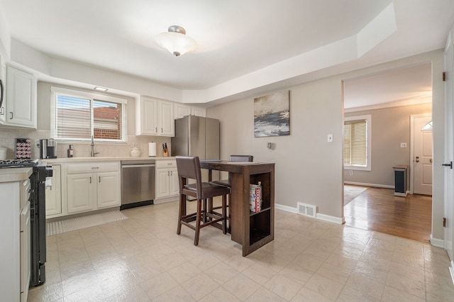 33466 Brownlea Dr, Sterling Heights, MI 48312 - kitchen with dishwasher, black range with gas cooktop, tasteful backsplash, light countertops, and white cabinets