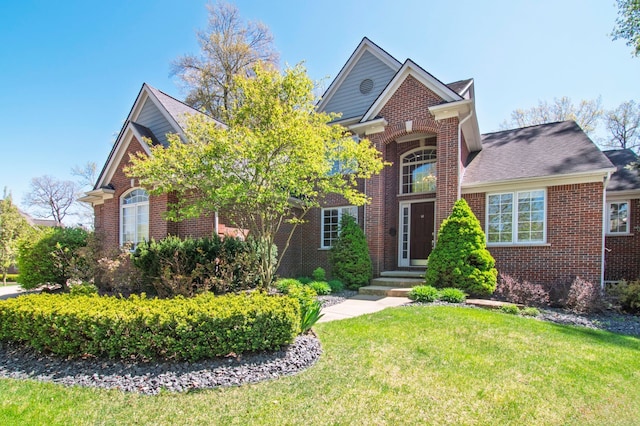 194 W Reed Lk, Commerce Twp, MI 48390 - traditional-style home with brick siding, a front yard, and roof with shingles