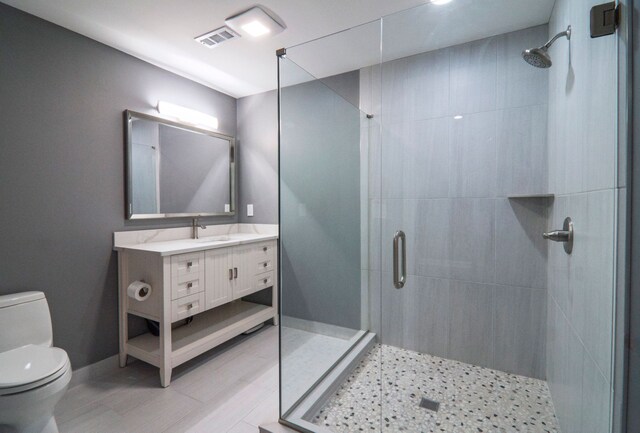 194 W Reed Lk, Commerce Twp, MI 48390 - bathroom with toilet, a stall shower, vanity, and baseboards