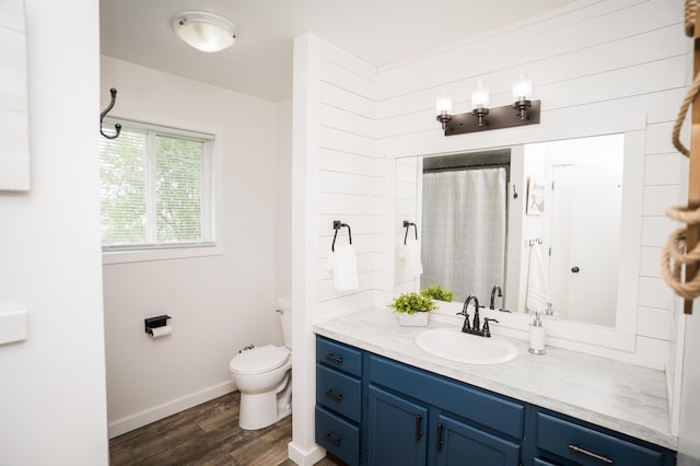 11748 Cloverview Dr, Ravenna, MI 49451 - bathroom with wood finished floors, toilet, vanity, baseboards, and a shower with shower curtain